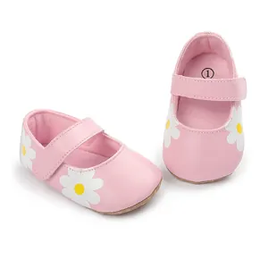 Detailed view of soft pink baby walker shoes featuring white daisy prints and strap