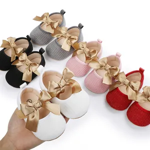 Vista detallada de zapatos de bebé princesa con lazos dorados en varios colores