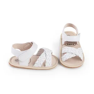 Detail view of white braided straps and soft sole on baby girl summer walker sandals