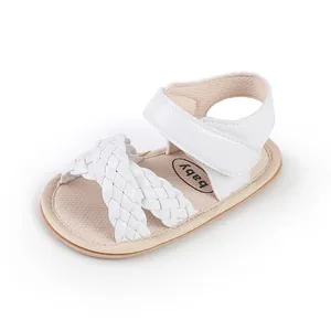 Close-up detail of white woven baby sandals with comfortable adjustable velcro strap