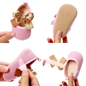 Vista detallada de los zapatos de princesa rosa para bebé con lazo dorado y velcro