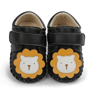 Gros plan de chaussures de marche pour bébé avec lion mignon et fermeture à scratch