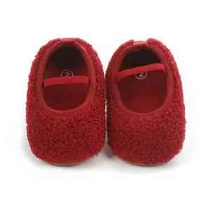 Detailed view of red fuzzy sherpa baby walking shoes with elastic strap