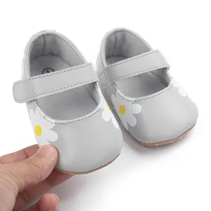 Close-up of gray baby walking shoes with cute daisy flower print and velcro strap