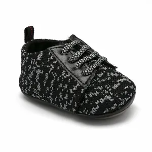 Breathable knit baby walking shoe with non-slip rubber sole in black and white.