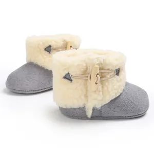 Detail view of infant winter snow boots with soft shearling and wooden toggle button