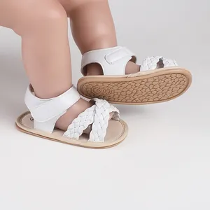White braided baby sandals with non-slip sole and practical Velcro closure detail