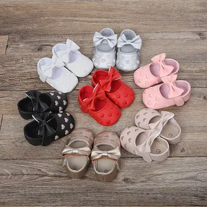Soft-sole baby walking shoes featuring heart pattern and decorative bow in various colors