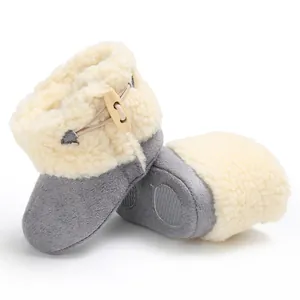 Detailed view of cozy baby winter snow boots with non-slip sole and toggle button