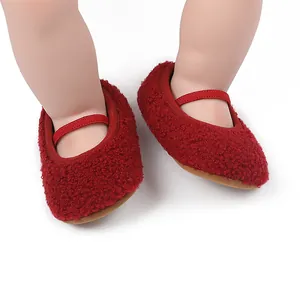 Detailed close-up view of cozy red fleece baby walking shoes with secure elastic strap