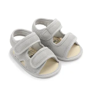 Close-up detail of grey mesh baby summer sandals with double velcro straps for secure fit