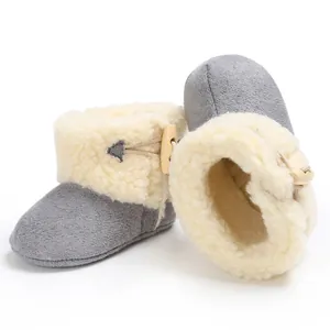 Macro view of plush-lined baby winter snow boots with wooden toggle button closure
