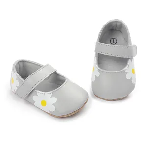 Detail view of grey baby walking shoes featuring white daisy floral prints.