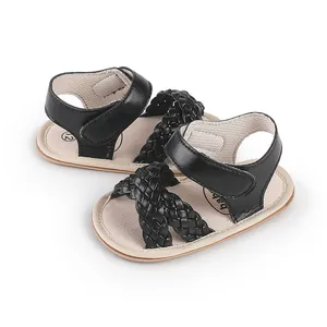 Detailed view of black braided baby girl sandals featuring comfortable Velcro ankle straps