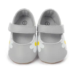 Detailed macro view of grey baby walking shoes featuring white daisy floral patterns