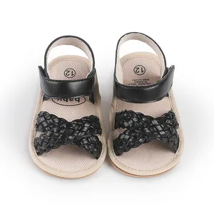 Top-down view of stylish black braided baby girl sandals with secure ankle strap