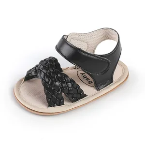 Detailed view of black woven straps on baby girl summer walking sandals