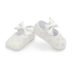 White infant soft-sole pre-walker shoes with embroidered hearts and cute bow decoration