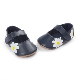 Detailed view of dark blue baby shoes with white daisy floral patterns