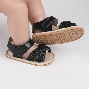 Detailed view of black braided baby girl sandals with flexible non-slip soles