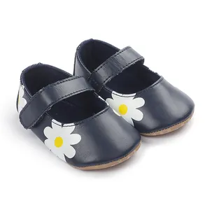 Detailed view of navy blue baby Mary Jane shoes with a white daisy floral print.