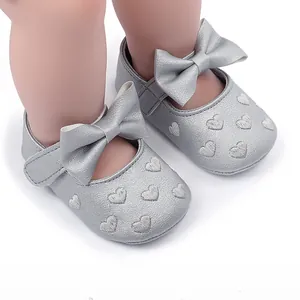 Detailansicht von silbernen Baby-Prinzessin-Laufschuhen mit Schleife und Herzstickerei