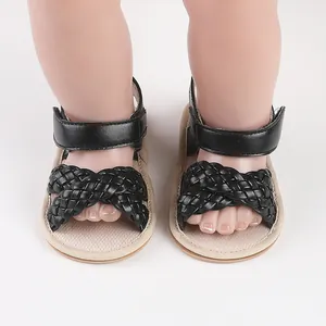 Close-up detail of black woven baby girl summer sandals on mannequin baby feet