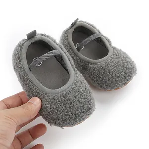 Detailed view of grey fuzzy baby shoes with soft fleece lining and elastic strap
