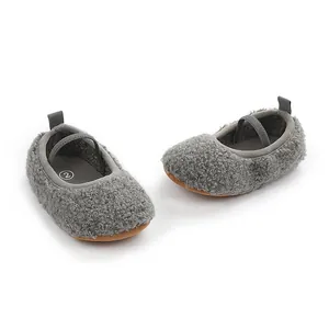 Detail view of gray fuzzy Sherpa fleece baby walking shoes with elastic strap.