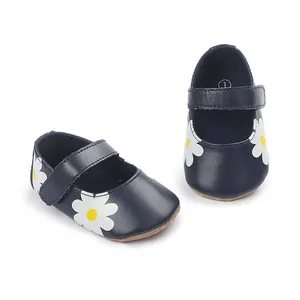 Detail of navy blue baby walking shoes with white daisy flower print and Velcro strap