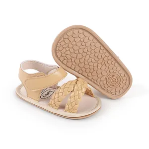 Detailed view of beige baby girl summer sandals featuring woven straps and a non-slip sole