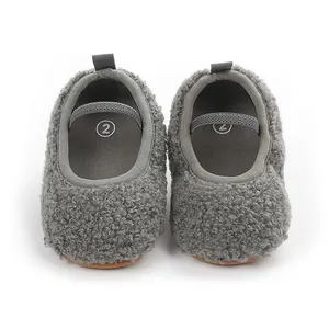 Detailed view of grey fuzzy sherpa baby slippers featuring elastic straps and soft soles