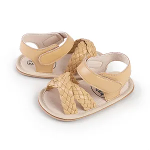 Detailed macro view of beige woven strap baby sandals with adjustable velcro for infants