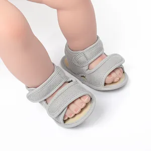 Detailed macro shot of grey breathable mesh baby walking sandals with secure velcro straps