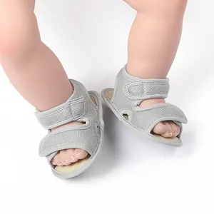 Close-up detail of soft grey mesh baby walking shoes with adjustable velcro straps