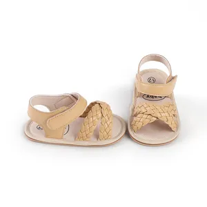 Close-up detail of beige braided baby sandals with soft soles for newborns