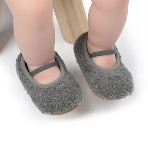 Close-up detail of soft grey fuzzy baby Mary Jane walking shoes with elastic straps