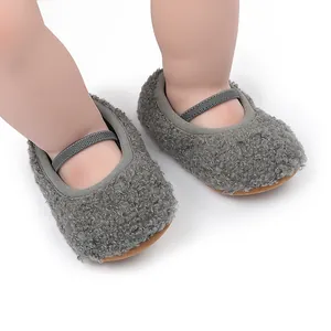 Close-up of grey fluffy sherpa baby walking shoes with elastic strap for comfort.