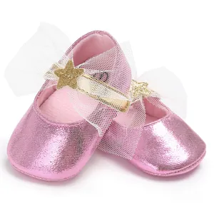 Detail von rosa Metallic-Baby-Prinzessin-Schuhen mit weißer Schleife und Stern