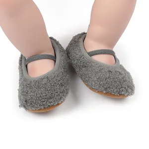Macro view of gray fuzzy fleece baby ballet shoes with elastic strap and soft sole