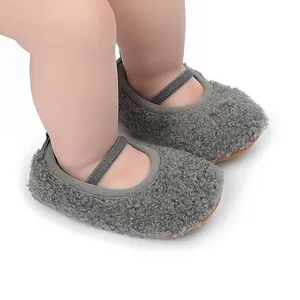 Detailed macro shot of gray fuzzy fleece baby walker shoes featuring a secure elastic strap
