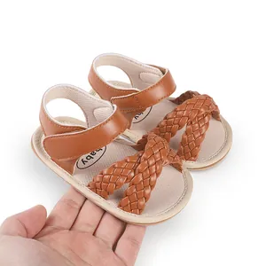 Detailed view of brown braided summer baby sandals for newborn girls' first steps