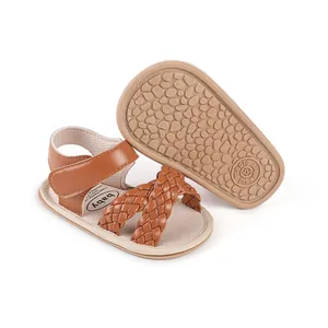 Detail view of baby walking sandals with braided straps and non-slip sole