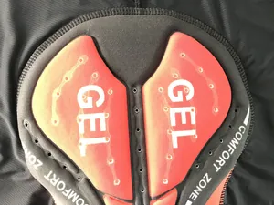 Close-up detail of the thickened red silicone gel seat pad for professional cycling shorts