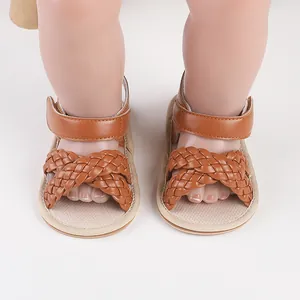 Close-up detail of brown braided baby girl sandals shown on mannequin feet for summer