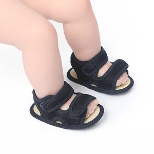Detailed close-up of black breathable mesh baby sandals with secure velcro straps