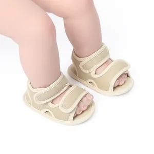 Detail showing beige mesh baby pre-walker sandals with dual straps on baby feet