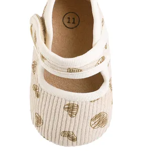 Detailed view of baby girl princess shoes featuring a heart pattern on corduroy fabric.