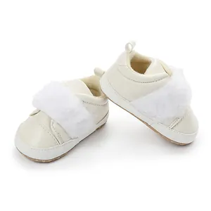 Close-up of white baby princess shoes with fluffy faux fur trim and non-slip soft soles