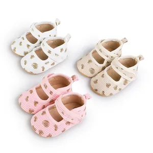 Collection of soft-soled baby walking shoes with heart patterns in white, beige, and pink